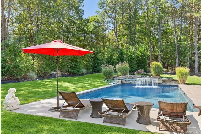 a view of a backyard with sitting area