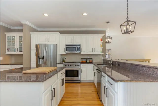 a kitchen with a sink stove and refrigerator