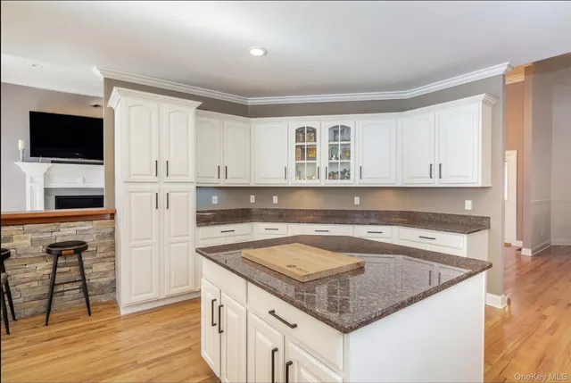 a kitchen with granite countertop a sink and a stove top oven