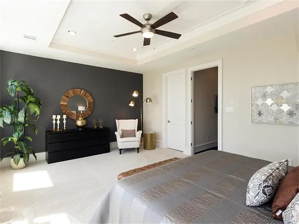 a bed room with a bed and a potted plant