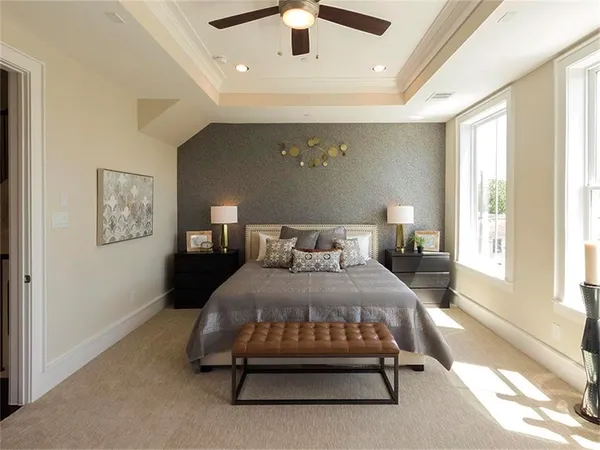 a bedroom with a bed and a chandelier