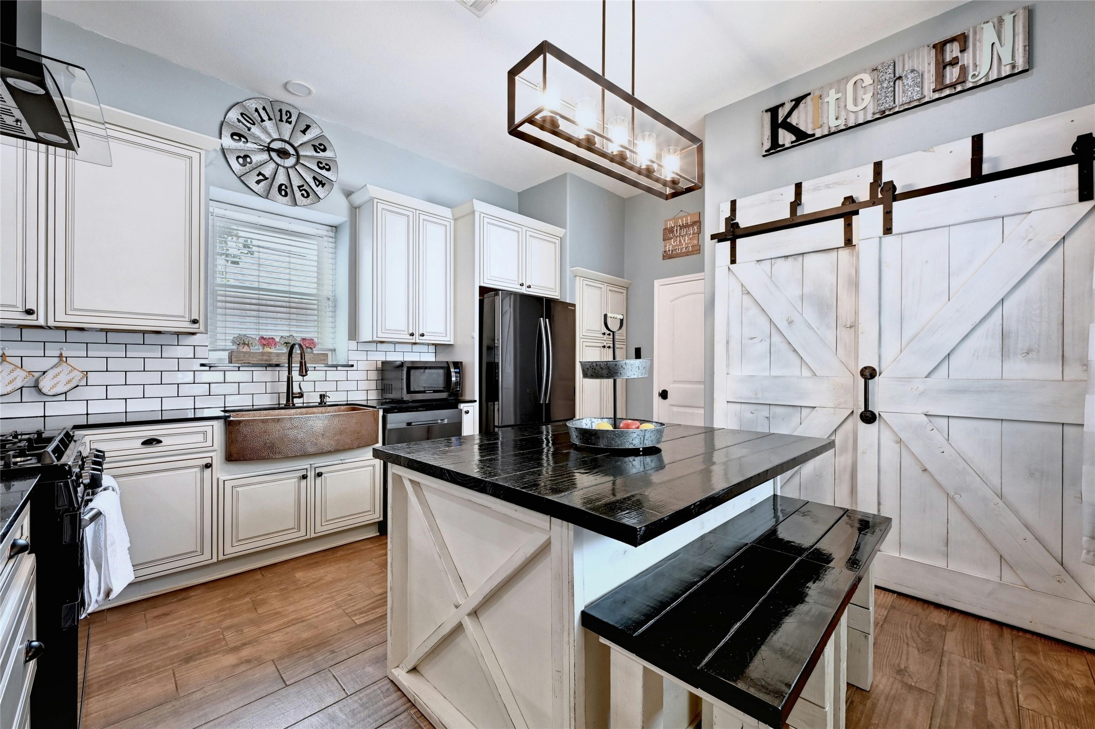 3012 Rochelle Drive Austin, TX 78748 - Photo 9 of 23 This kitchen is upgraded with quartz countertops, modern light fixtures, and a gorgeous sink.
