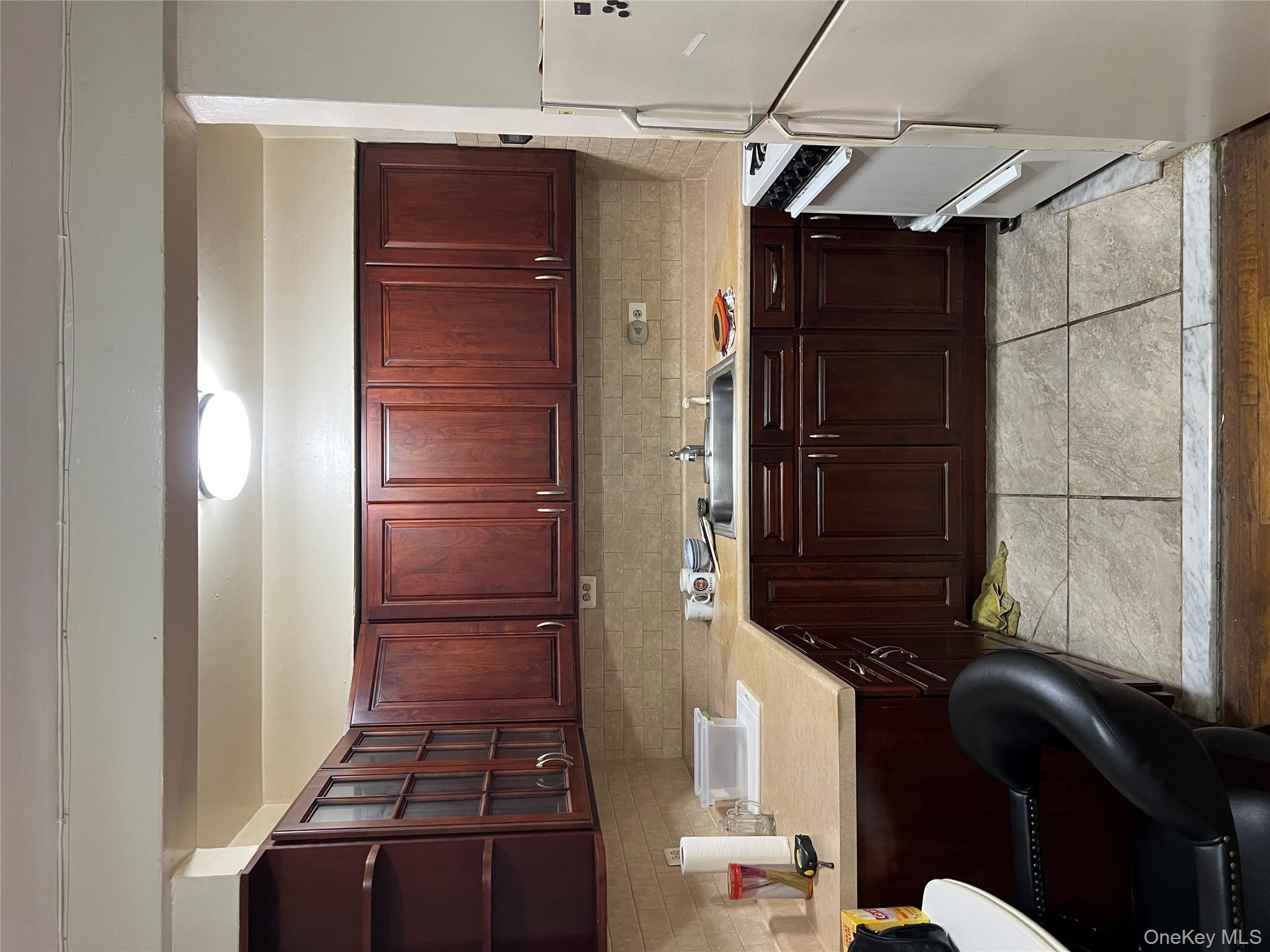84-20 51st Avenue, Unit 6H Queens, NY 11373 - Photo 7 of 8 a kitchen with a sink and cabinets