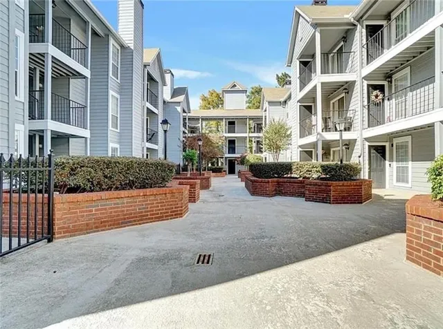 a view of a building with cars parked on road