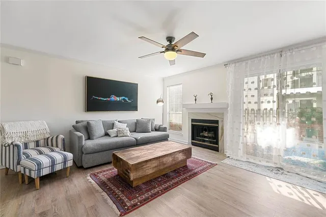 a living room with furniture a fireplace and a flat screen tv