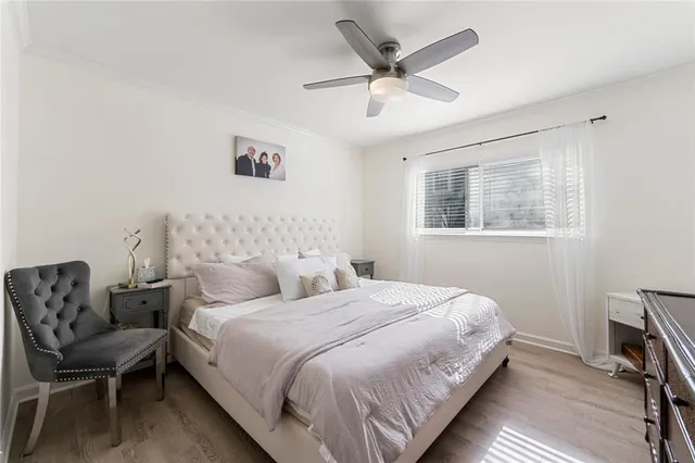 a bedroom with a bed a couch and a window