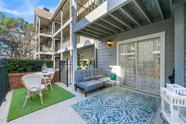 a view of a patio with couple of chairs and a patio