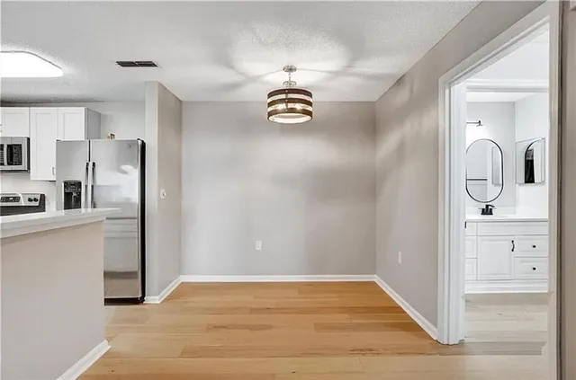 a view of a hallway with wooden floor