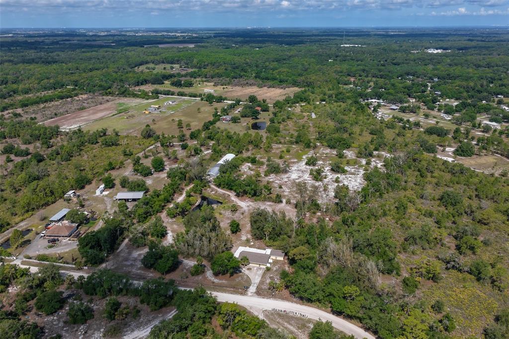 14451 Highland Road Wimauma, FL 33598 - Photo 74 of 80 an aerial view of residential house with outdoor space and trees around