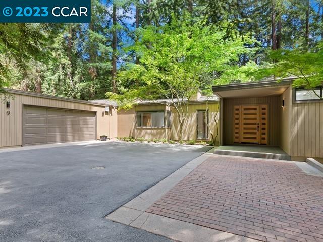 9 Redwood Circle Lafayette, CA 94549 - Photo 2 of 36 a front view of a house with a yard and garage