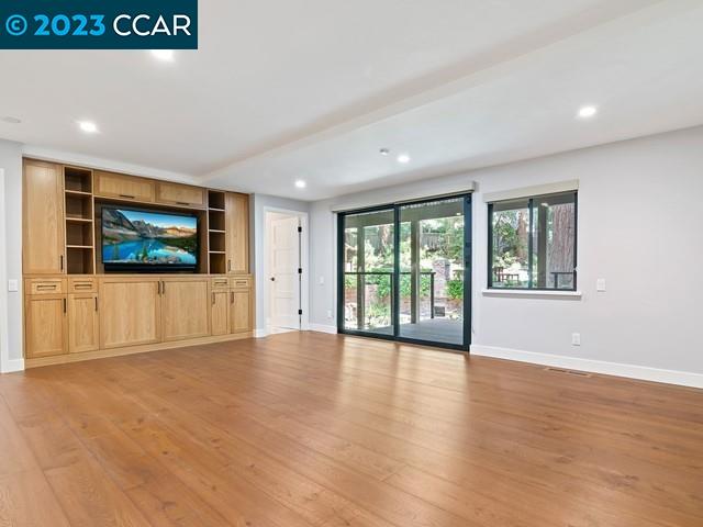 9 Redwood Circle Lafayette, CA 94549 - Photo 22 of 36 a view of an empty room with a window and wooden floor