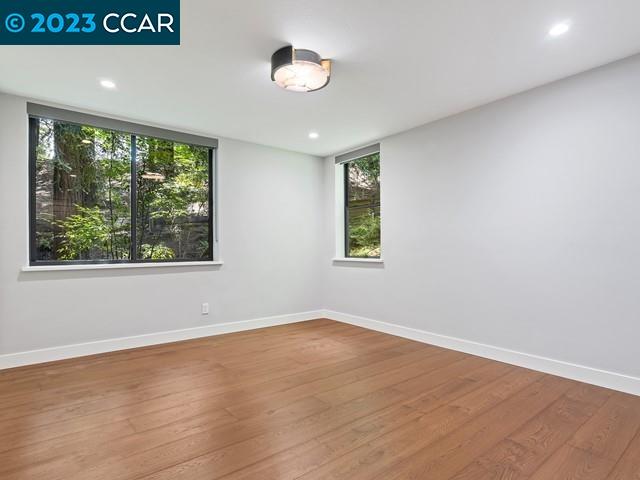9 Redwood Circle Lafayette, CA 94549 - Photo 23 of 36 an empty room with wooden floor and windows