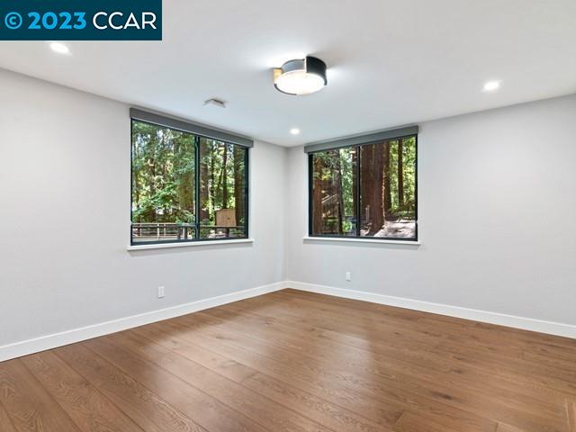 9 Redwood Circle Lafayette, CA 94549 - Photo 24 of 36 an empty room with wooden floor and windows