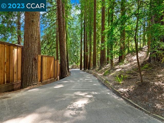 9 Redwood Circle Lafayette, CA 94549 - Photo 36 of 36 a view of a backyard with large trees and wooden fence