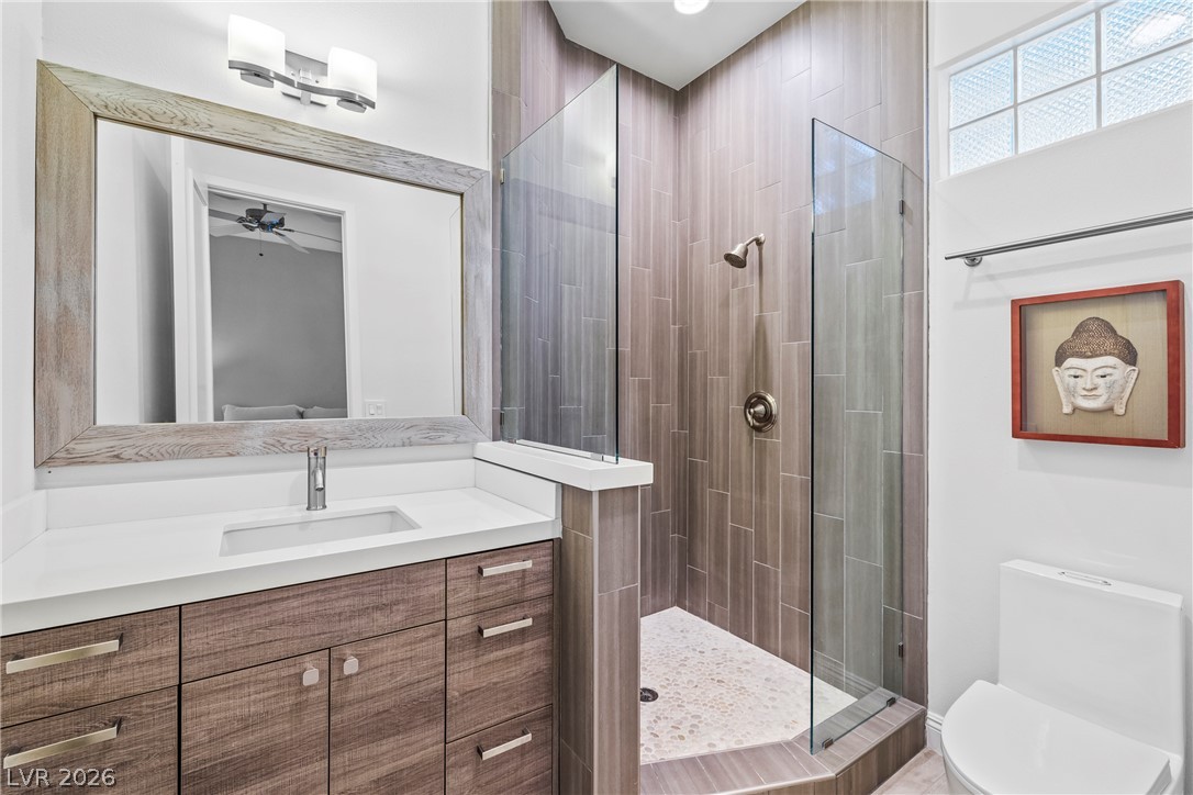 2000 Grouse Street Las Vegas, NV 89134 - Photo 11 of 89 A well-appointed bathroom with a spacious vanity, walk-in shower, and ample natural light.