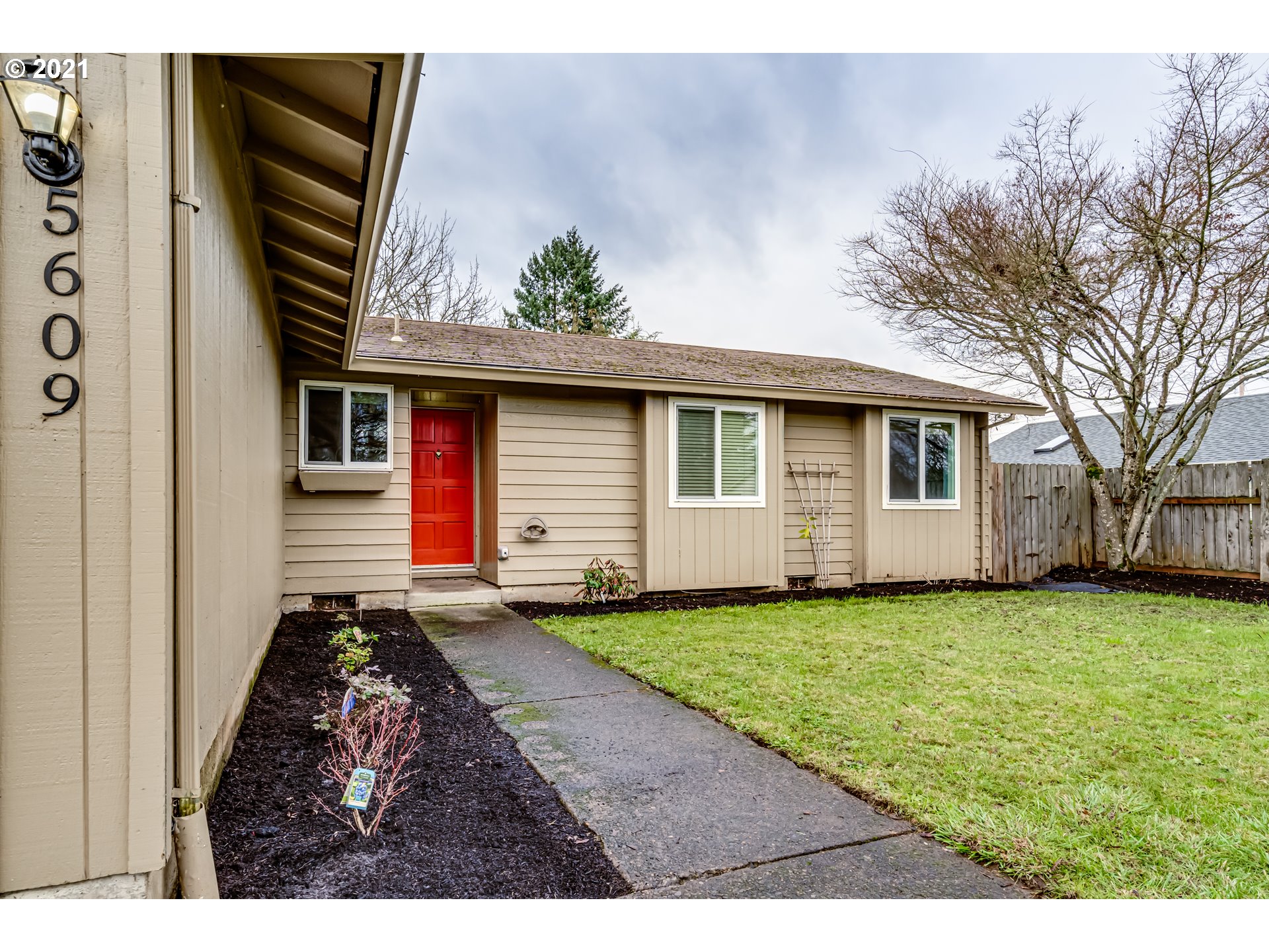 5609 C Street Springfield, OR 97478 - Photo 2 of 26 a view of backyard with a garden and deck
