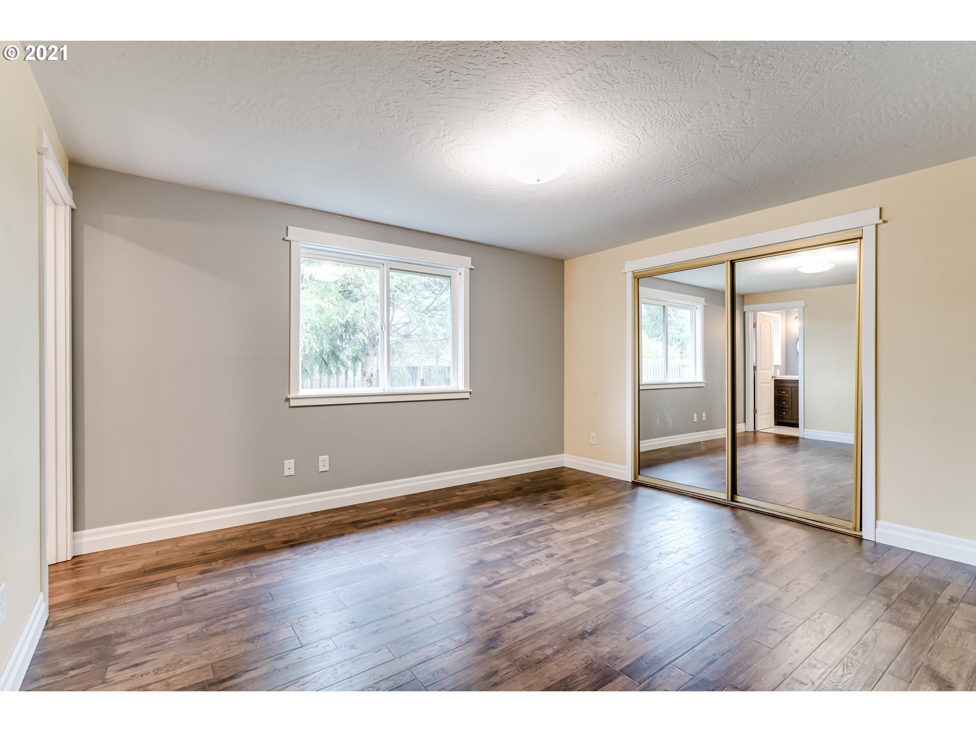 5609 C Street Springfield, OR 97478 - Photo 12 of 26 an empty room with wooden floor and windows