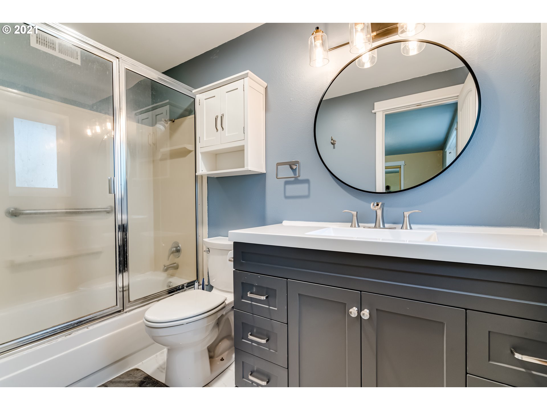 5609 C Street Springfield, OR 97478 - Photo 14 of 26 a bathroom with a toilet a sink and mirror