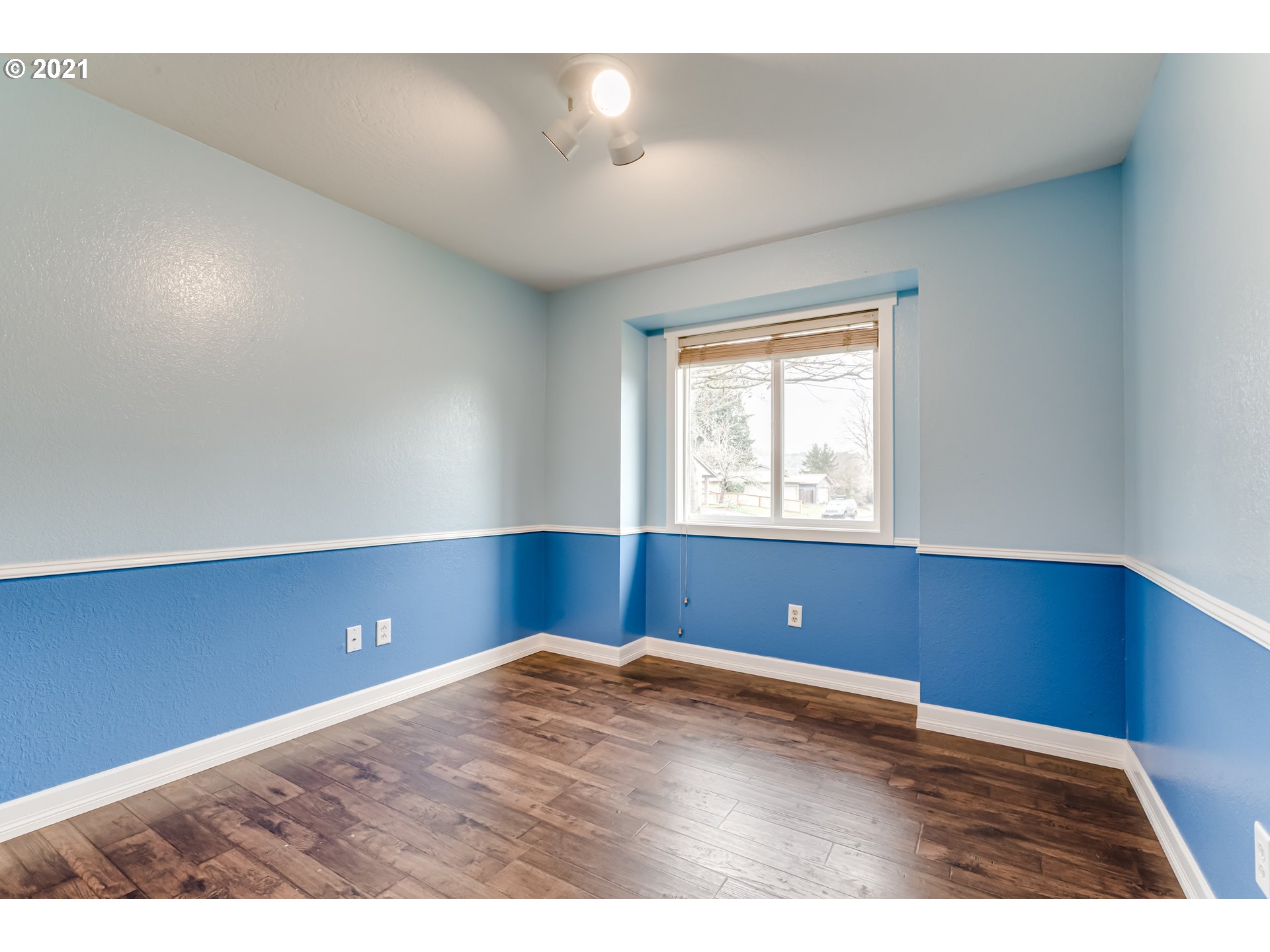 5609 C Street Springfield, OR 97478 - Photo 15 of 26 a view of room with wooden floor and windows