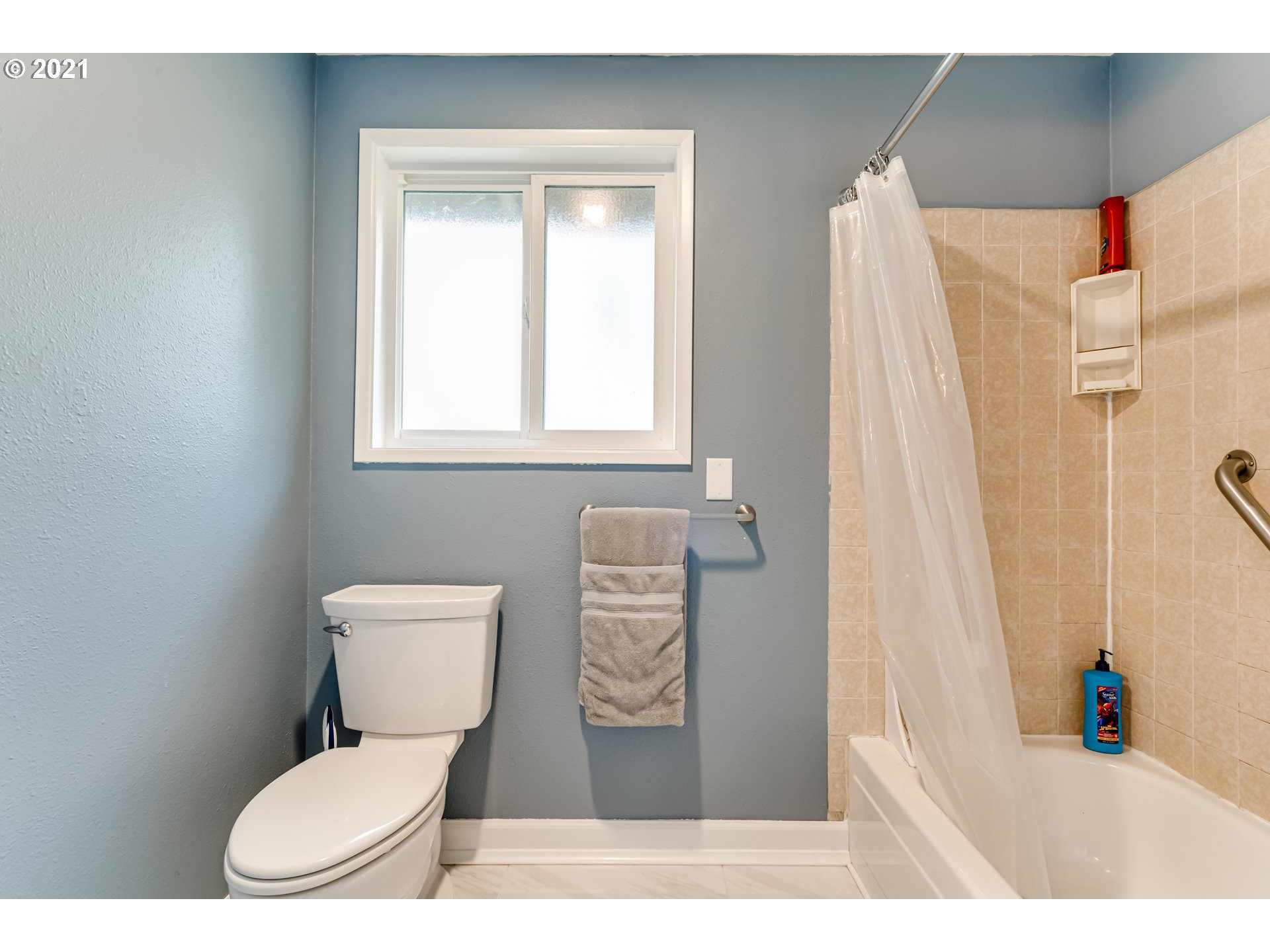 5609 C Street Springfield, OR 97478 - Photo 19 of 26 a bathroom with a toilet sink and shower curtain