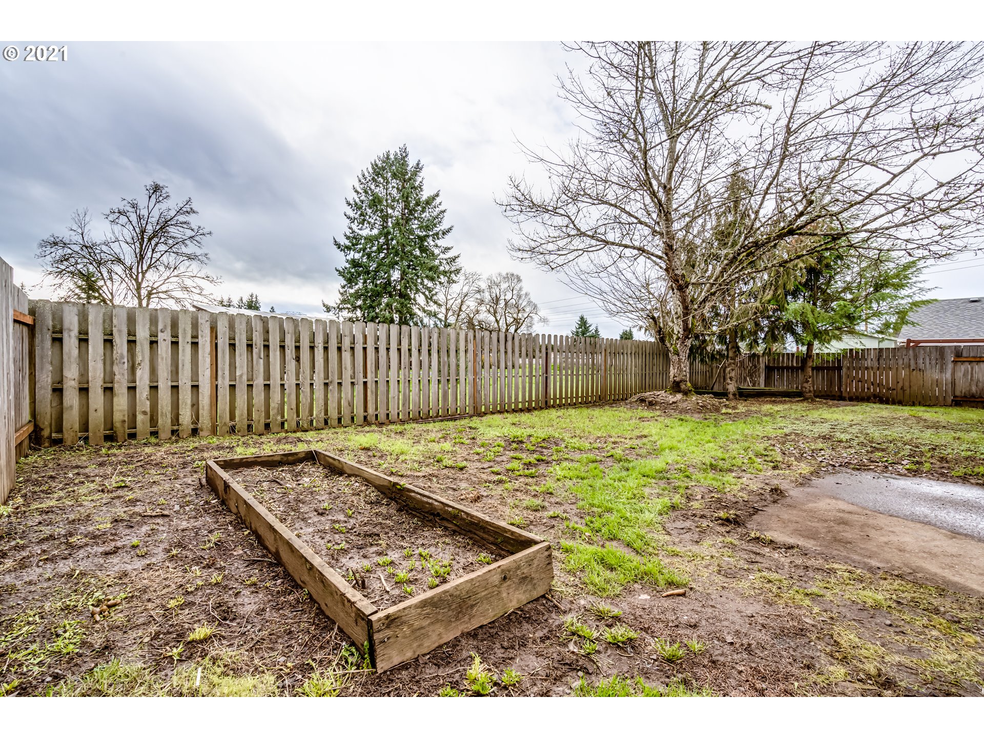 5609 C Street Springfield, OR 97478 - Photo 23 of 26 a view of a backyard with wooden fence