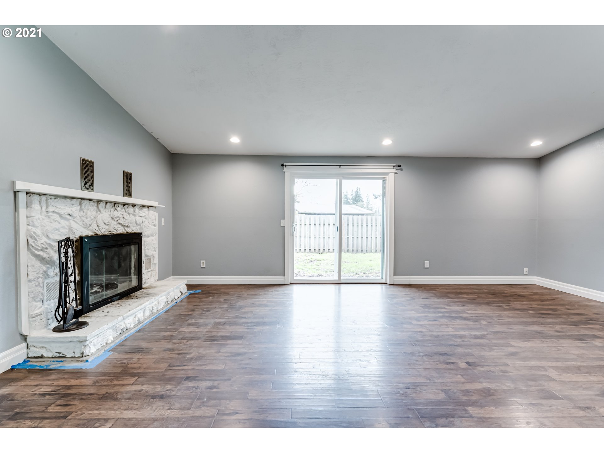 5609 C Street Springfield, OR 97478 - Photo 4 of 26 a view of an empty room with wooden floor fireplace and a window