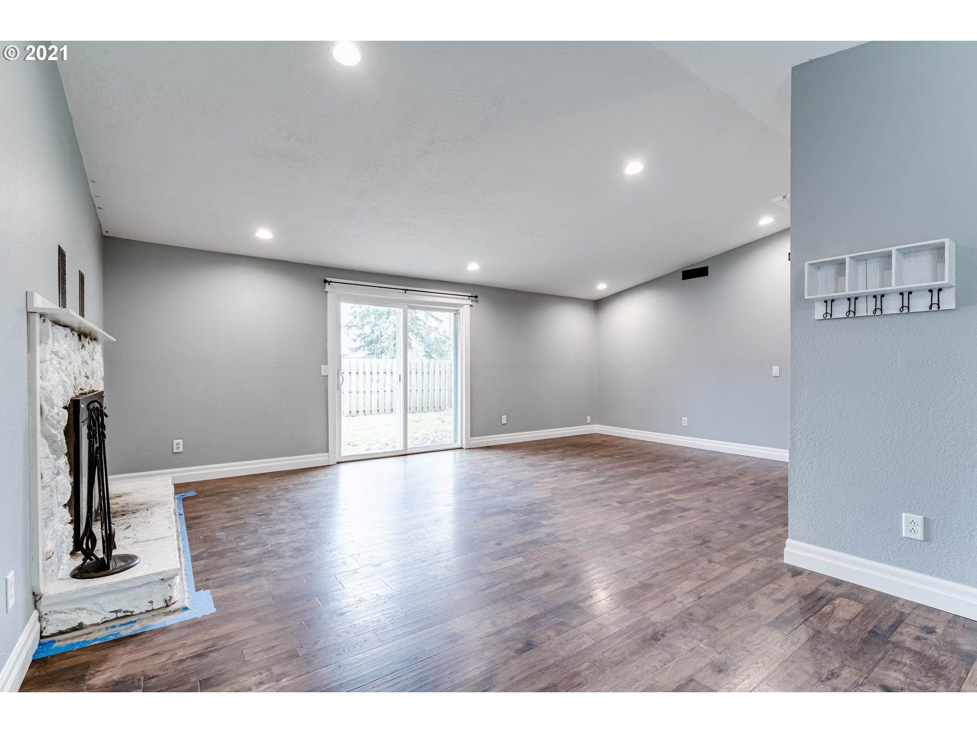 5609 C Street Springfield, OR 97478 - Photo 5 of 26 a view of an empty room with window and wooden floor