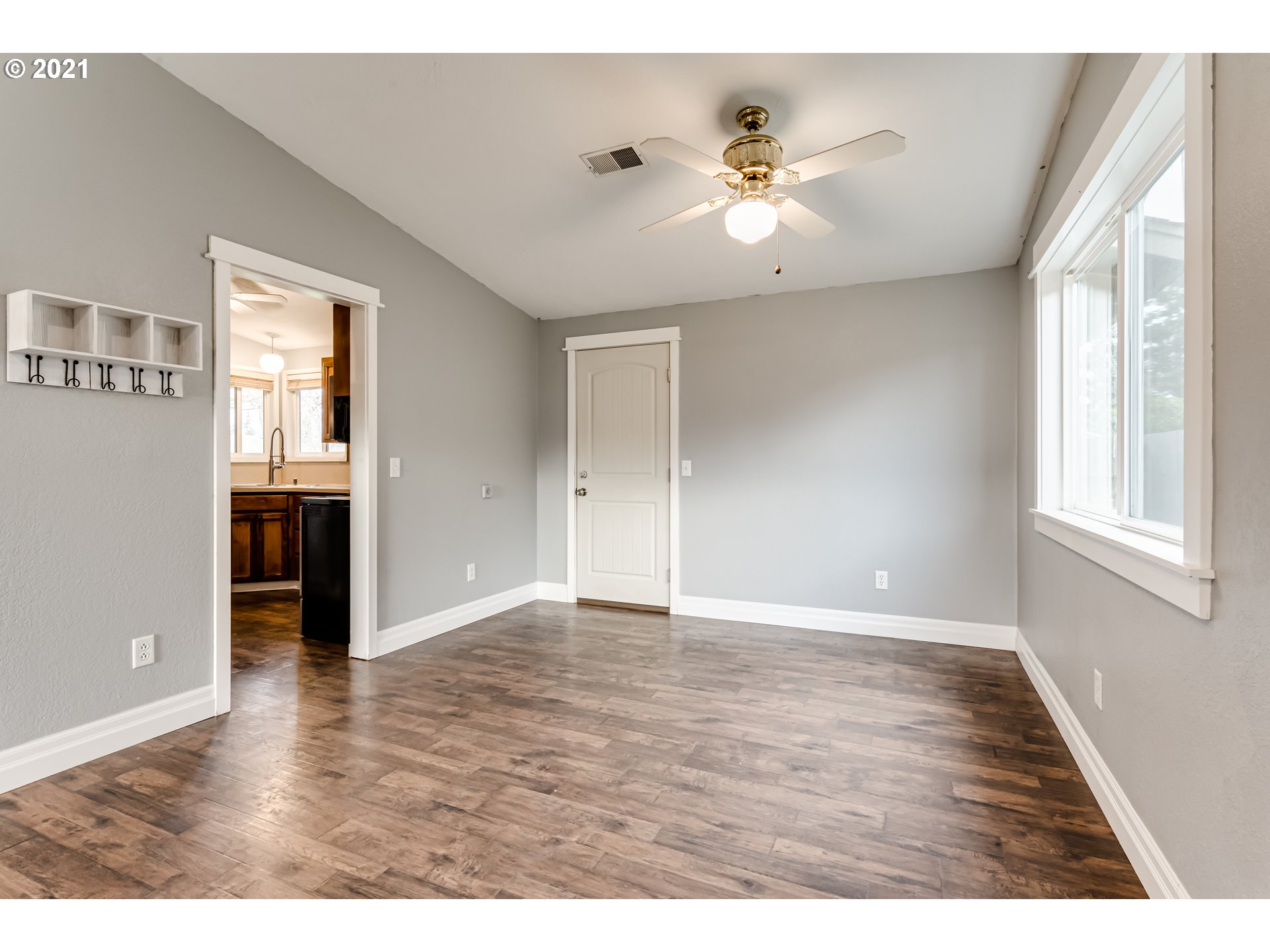 5609 C Street Springfield, OR 97478 - Photo 7 of 26 a view of an empty room with wooden floor and a window