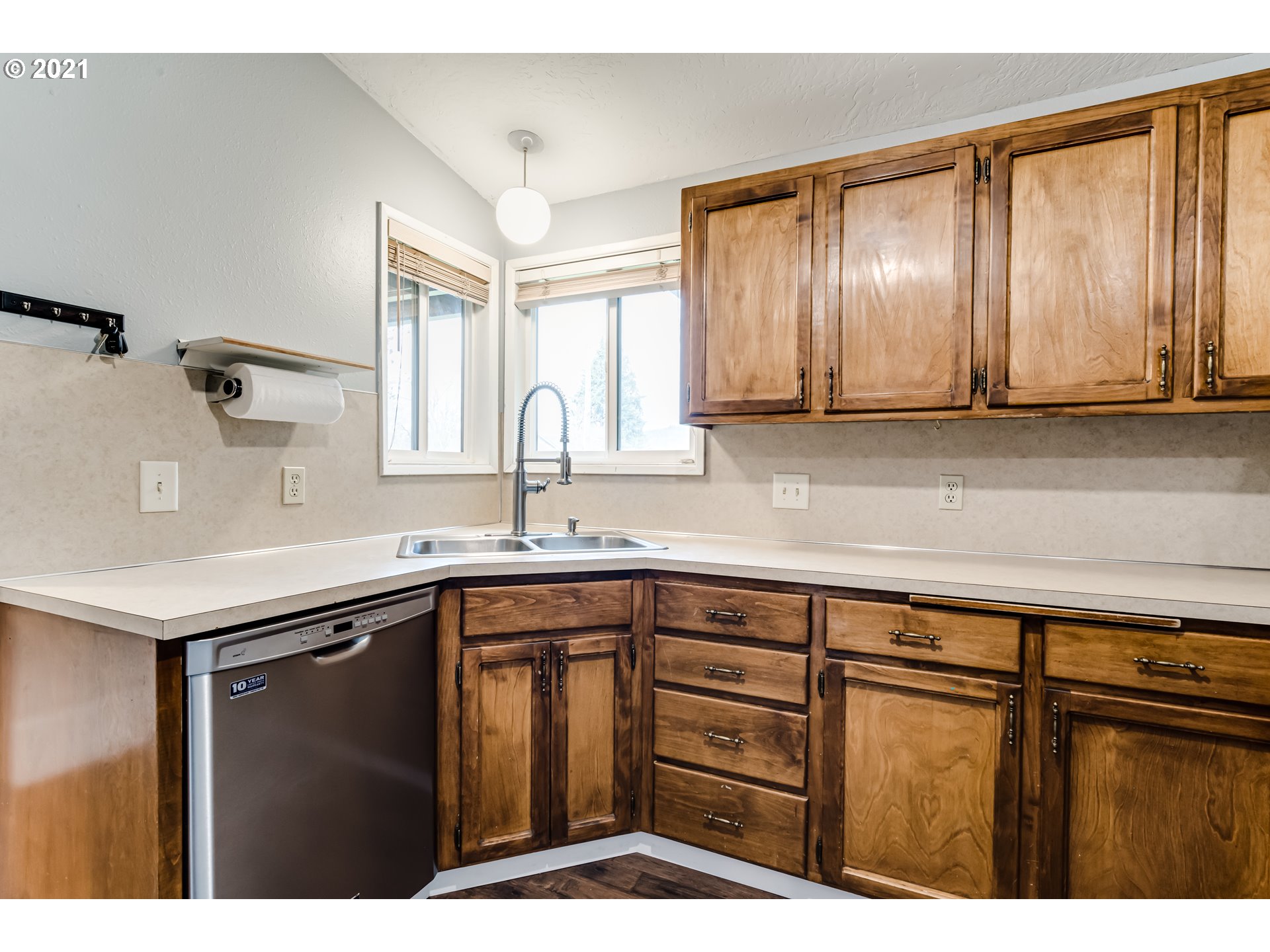 5609 C Street Springfield, OR 97478 - Photo 9 of 26 a kitchen with a sink window and cabinets