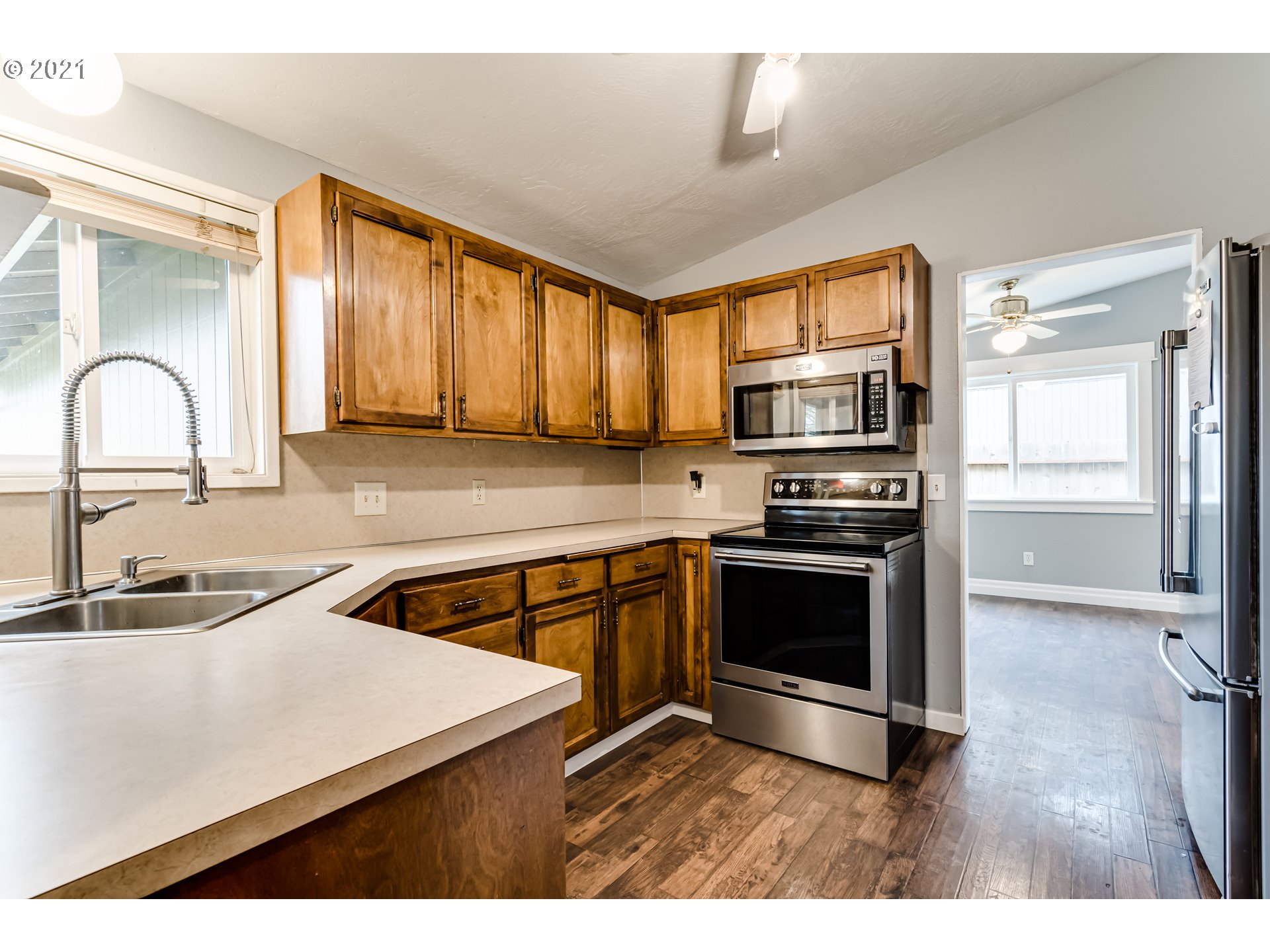 5609 C Street Springfield, OR 97478 - Photo 10 of 26 a kitchen with kitchen island granite countertop a stove and a sink with granite countertops