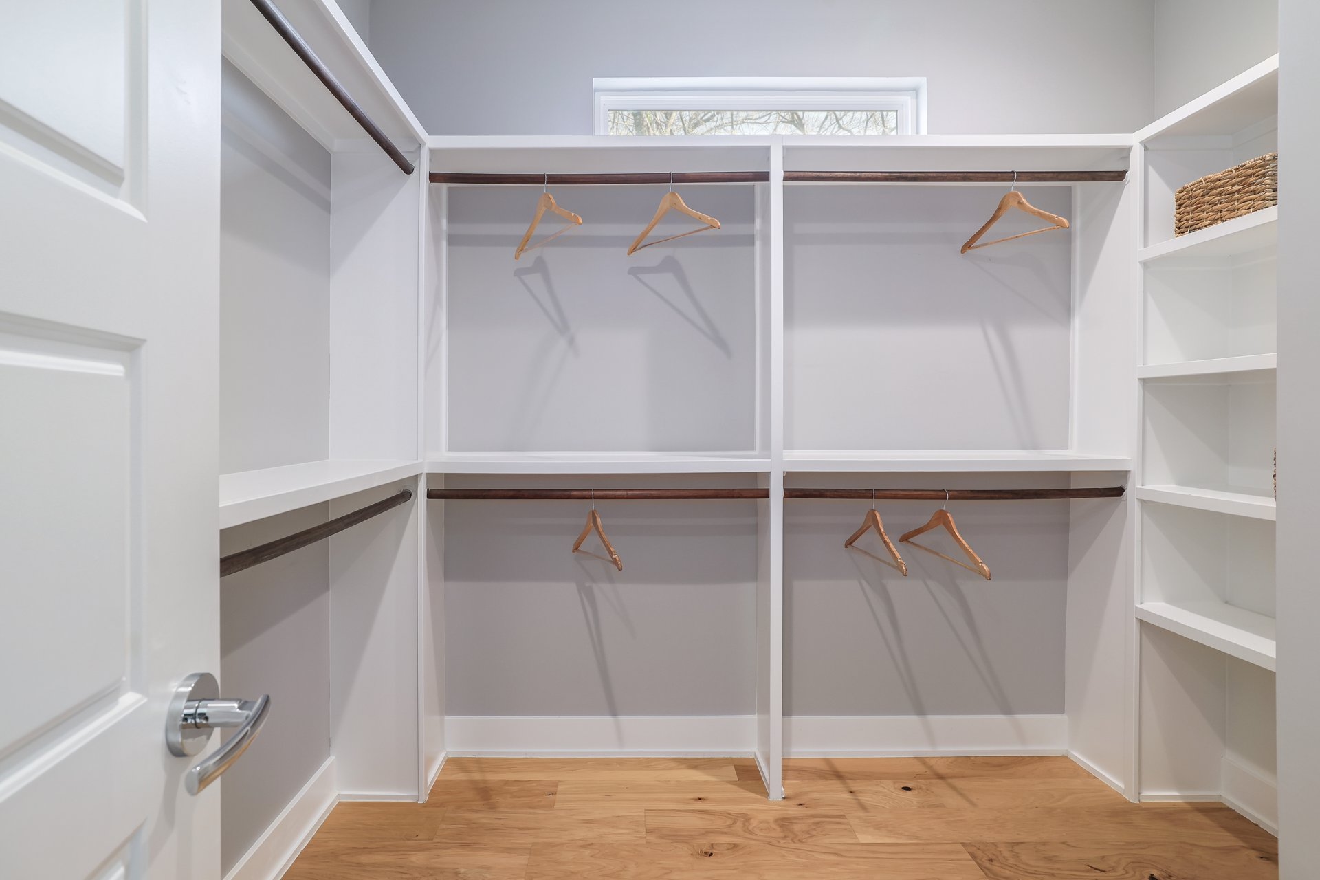 1103 Saucedo Street, Unit B Austin, TX 78721 - Photo 17 of 26 The primary suite includes a large walk-in closet with built-in shelving, offering significant storage and organization space