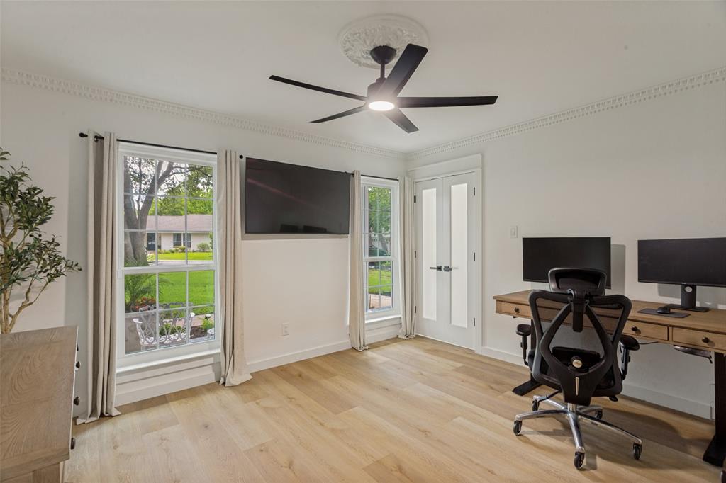 4316 Springbranch Drive Benbrook, TX 76116 - Photo 23 of 39 Bright interior space featuring light wood-finish flooring, a modern ceiling fan with light, and ornate crown molding