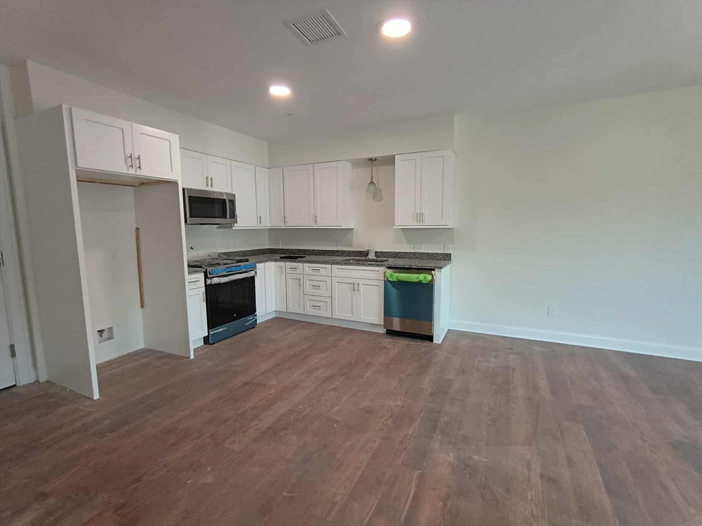 10 Franklin Avenue, Unit 402 Revere, MA 02151 - Photo 2 of 15 a kitchen with stainless steel appliances granite countertop a stove a sink and a refrigerator