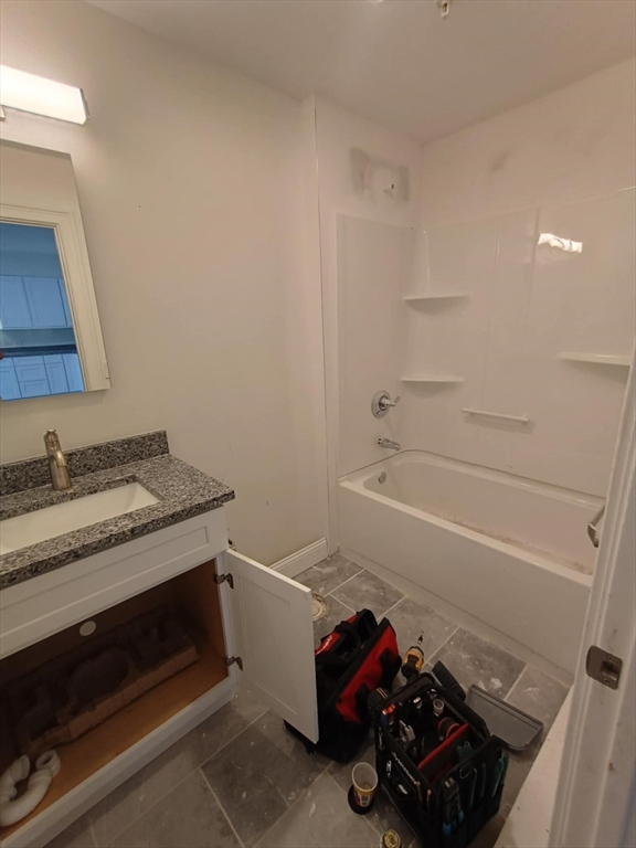 10 Franklin Avenue, Unit 402 Revere, MA 02151 - Photo 8 of 15 a bathroom with a granite countertop sink a toilet and bathtub