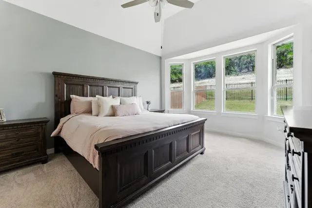 a bedroom with a bed closet and flat tv screen