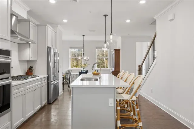 a kitchen with counter top space a sink stainless steel appliances and cabinets