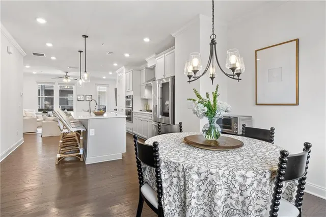 a kitchen with stainless steel appliances kitchen island granite countertop a table and chairs