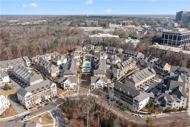 a living room with lots of furniture and kitchen view