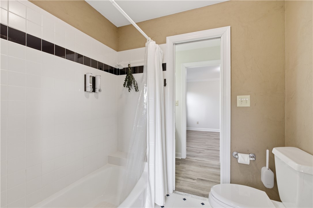 501 Capri Point Lavonia, GA 30553 - Photo 37 of 50 This bathroom features classic tile work and a convenient tub/shower combination, ensuring comfort and utility.