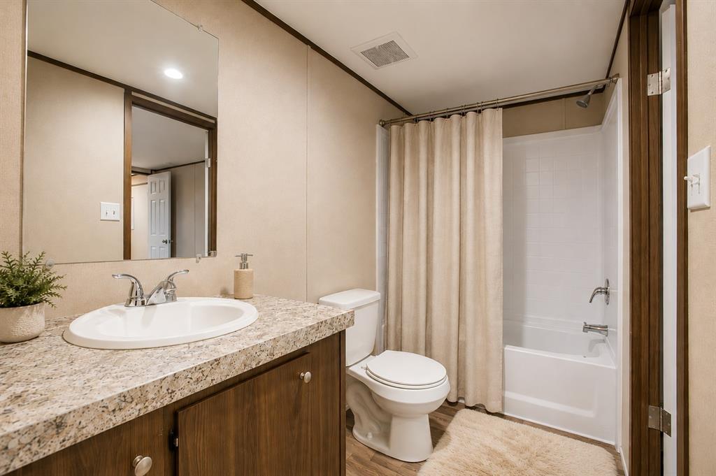 1206 Hayes Road Sherman, TX 75090 - Photo 10 of 21 a bathroom with a granite countertop sink toilet and shower