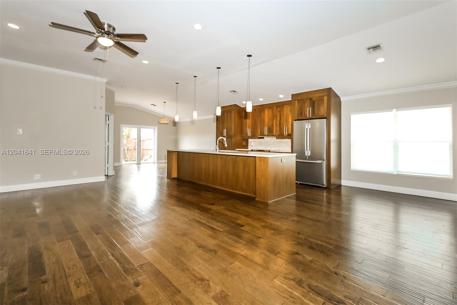 6484 Robinson Street Jupiter, FL 33458 - Photo 4 of 15 a kitchen with stainless steel appliances granite countertop a refrigerator a sink and a stove