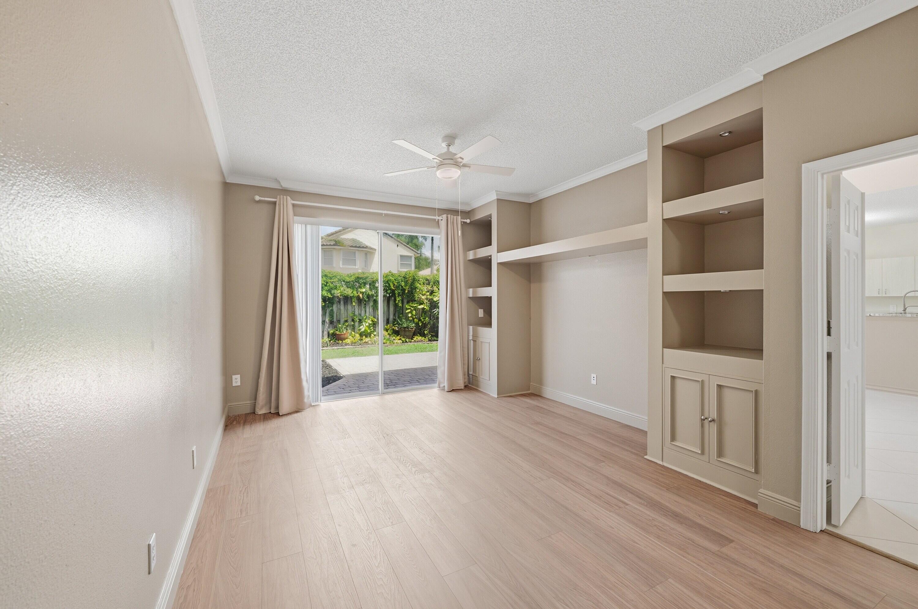 18474 Old Princeton Lane Boca Raton, FL 33498 - Photo 23 of 46 a view of empty room with wooden floor and fan