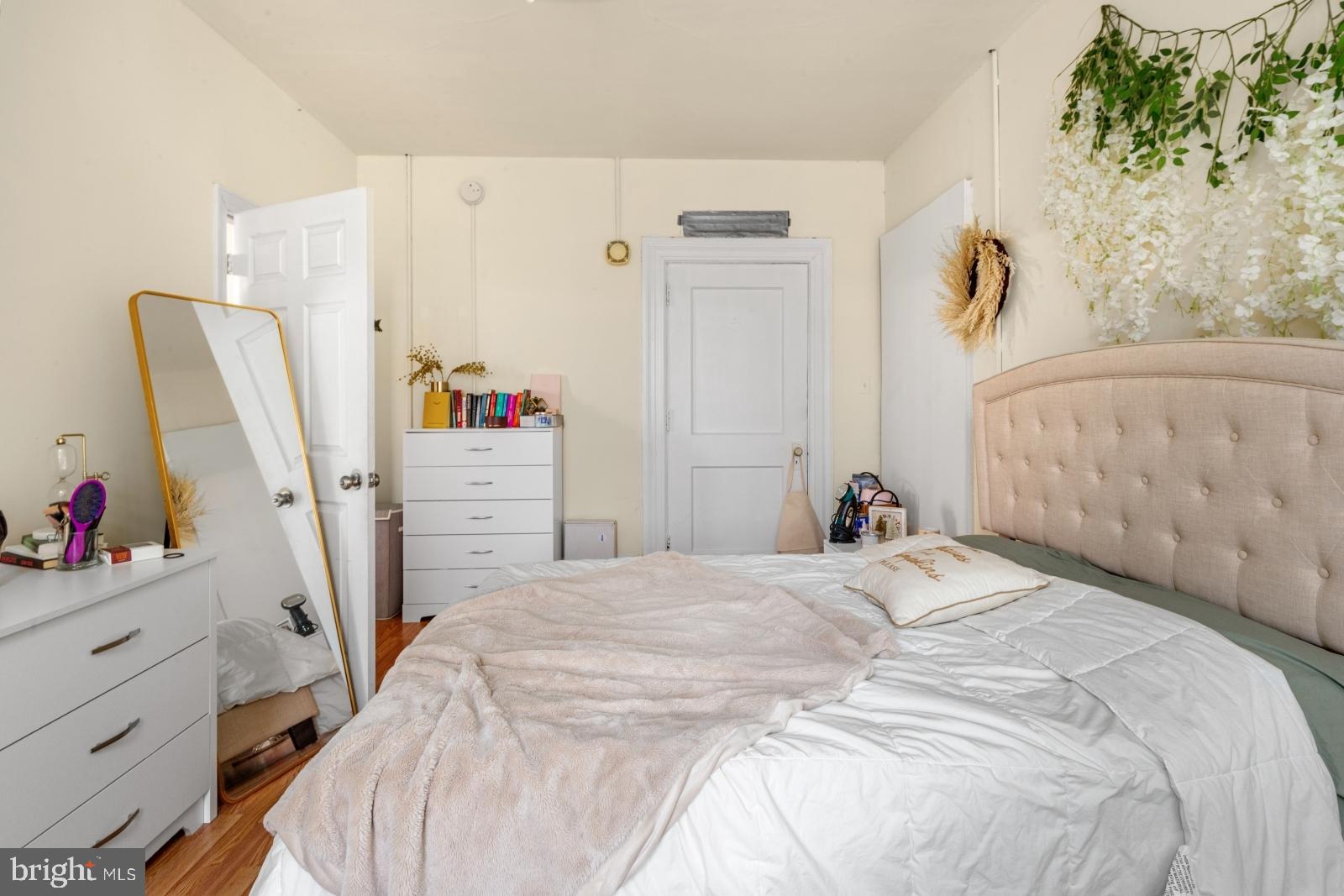1324 Locust Street, Unit 1503 Philadelphia, PA 19107 - Photo 11 of 38 a bedroom with a bed and a dresser
