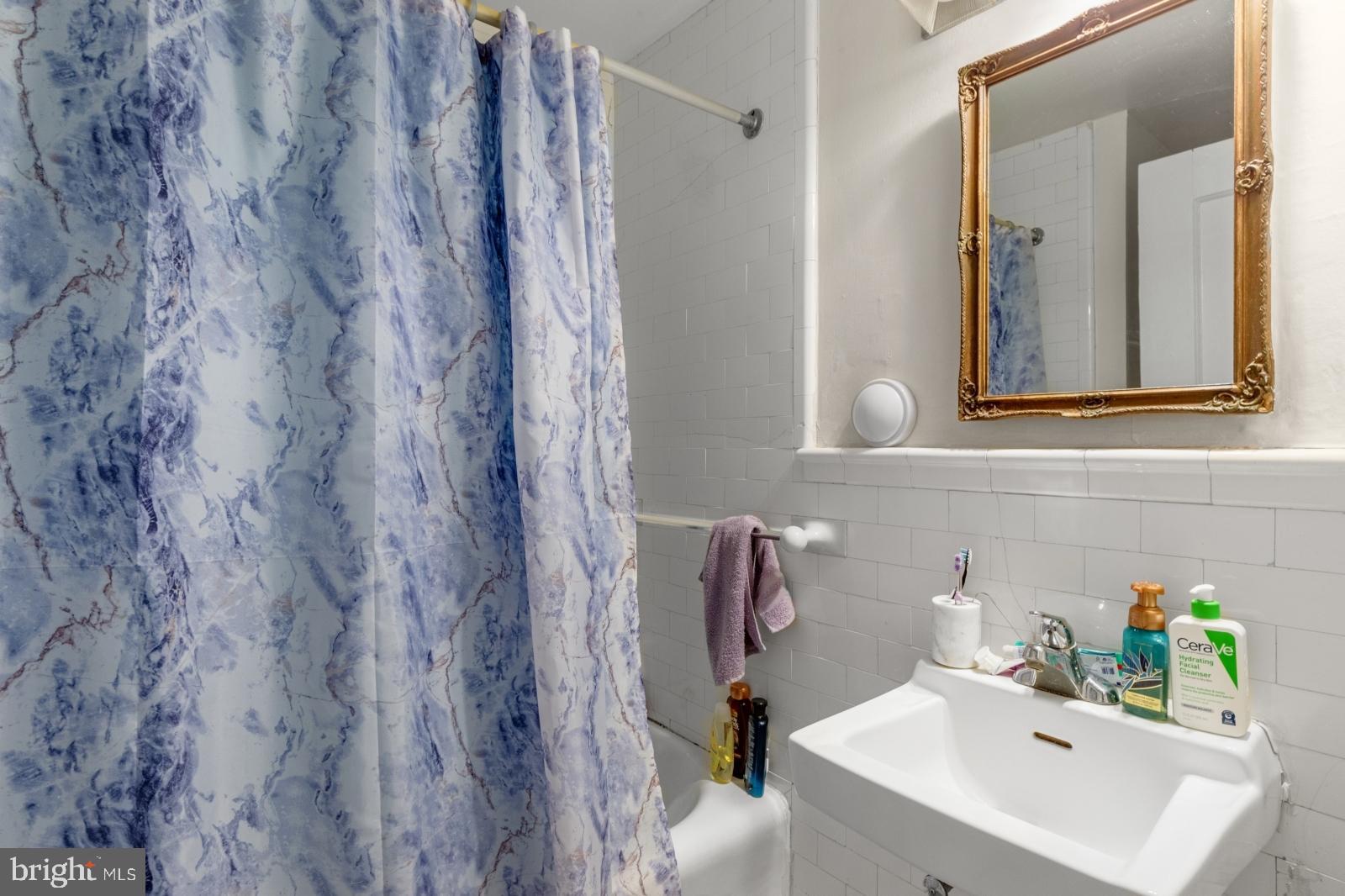 1324 Locust Street, Unit 1503 Philadelphia, PA 19107 - Photo 12 of 38 a bathroom with a sink and a mirror