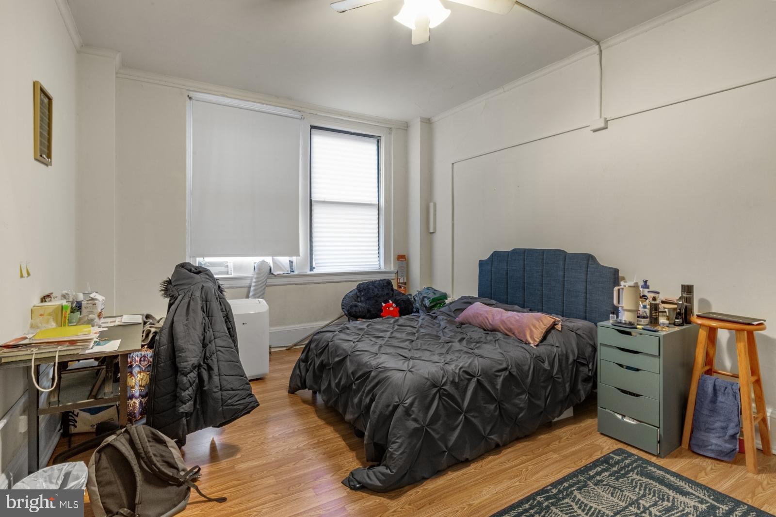 1324 Locust Street, Unit 1503 Philadelphia, PA 19107 - Photo 13 of 38 a bedroom with a bed and a chandelier
