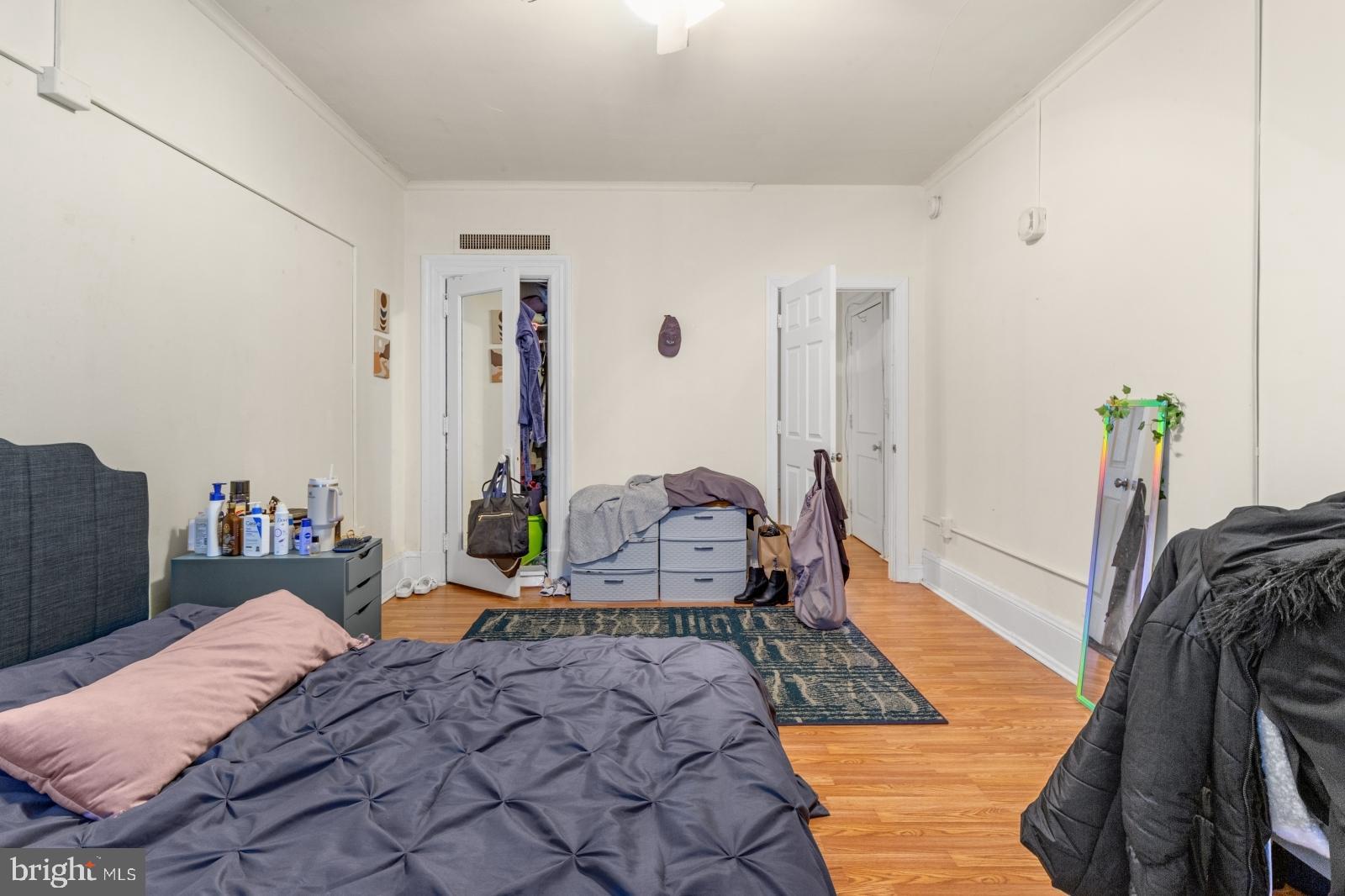 1324 Locust Street, Unit 1503 Philadelphia, PA 19107 - Photo 15 of 38 a bedroom with bed and walk in closet