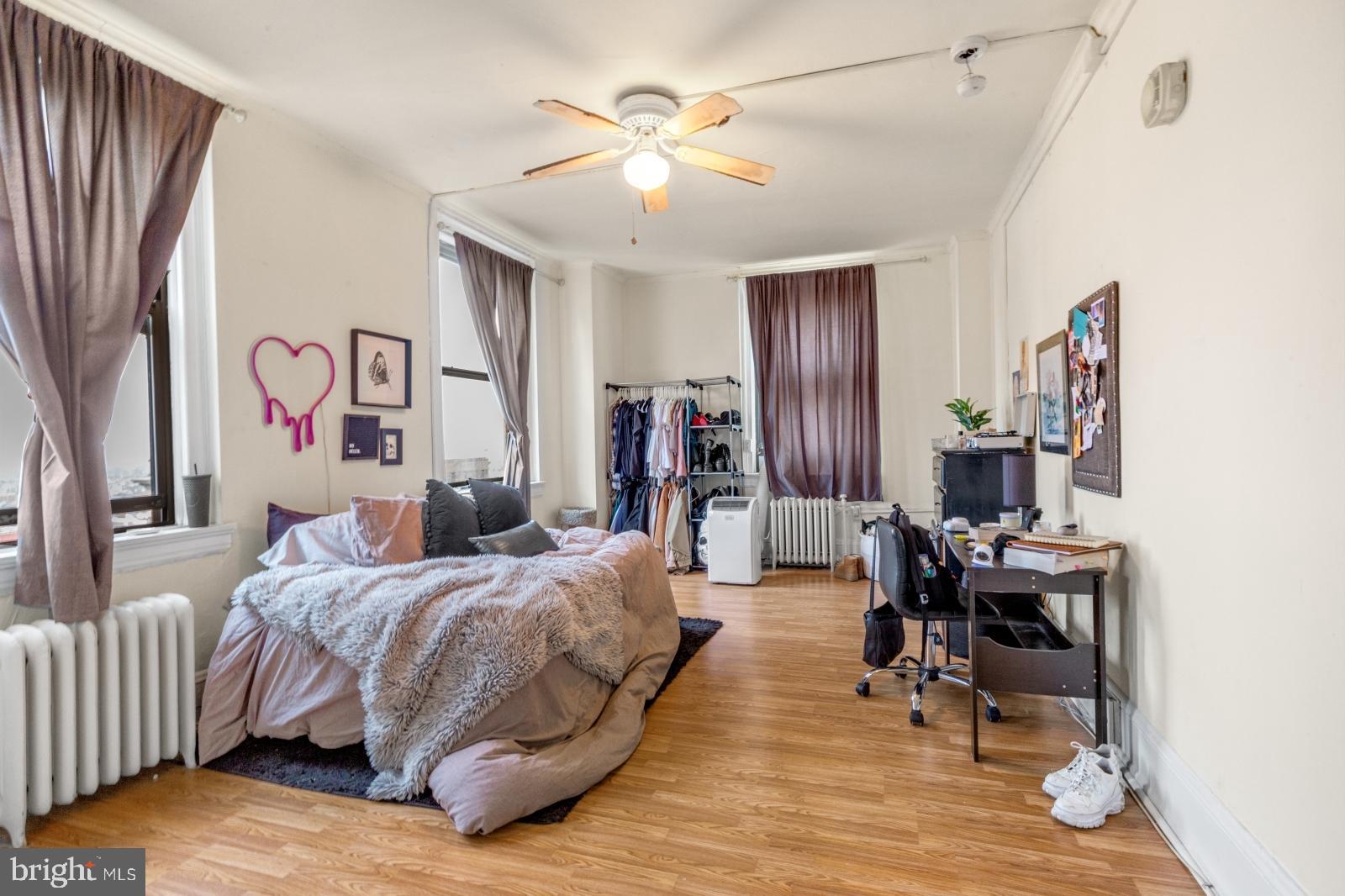 1324 Locust Street, Unit 1503 Philadelphia, PA 19107 - Photo 16 of 38 a bedroom with a bed and a table