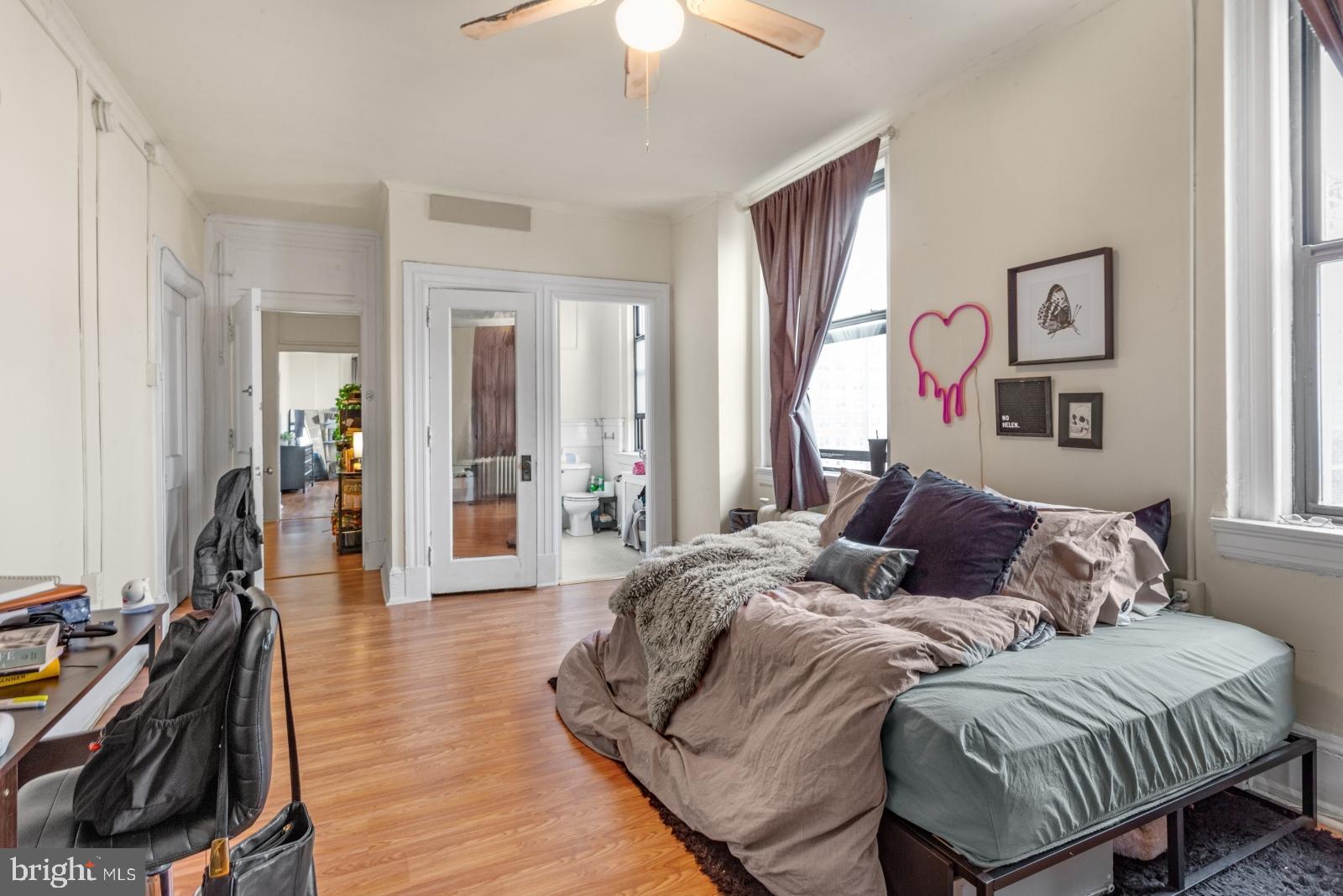 1324 Locust Street, Unit 1503 Philadelphia, PA 19107 - Photo 19 of 38 a bedroom with bed and a chandelier