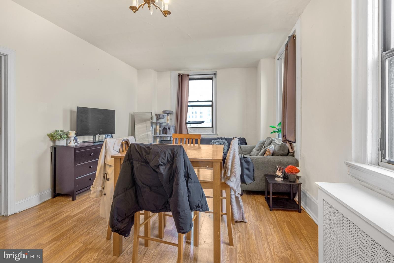 1324 Locust Street, Unit 1503 Philadelphia, PA 19107 - Photo 2 of 38 a living room with furniture a flat screen tv and a window
