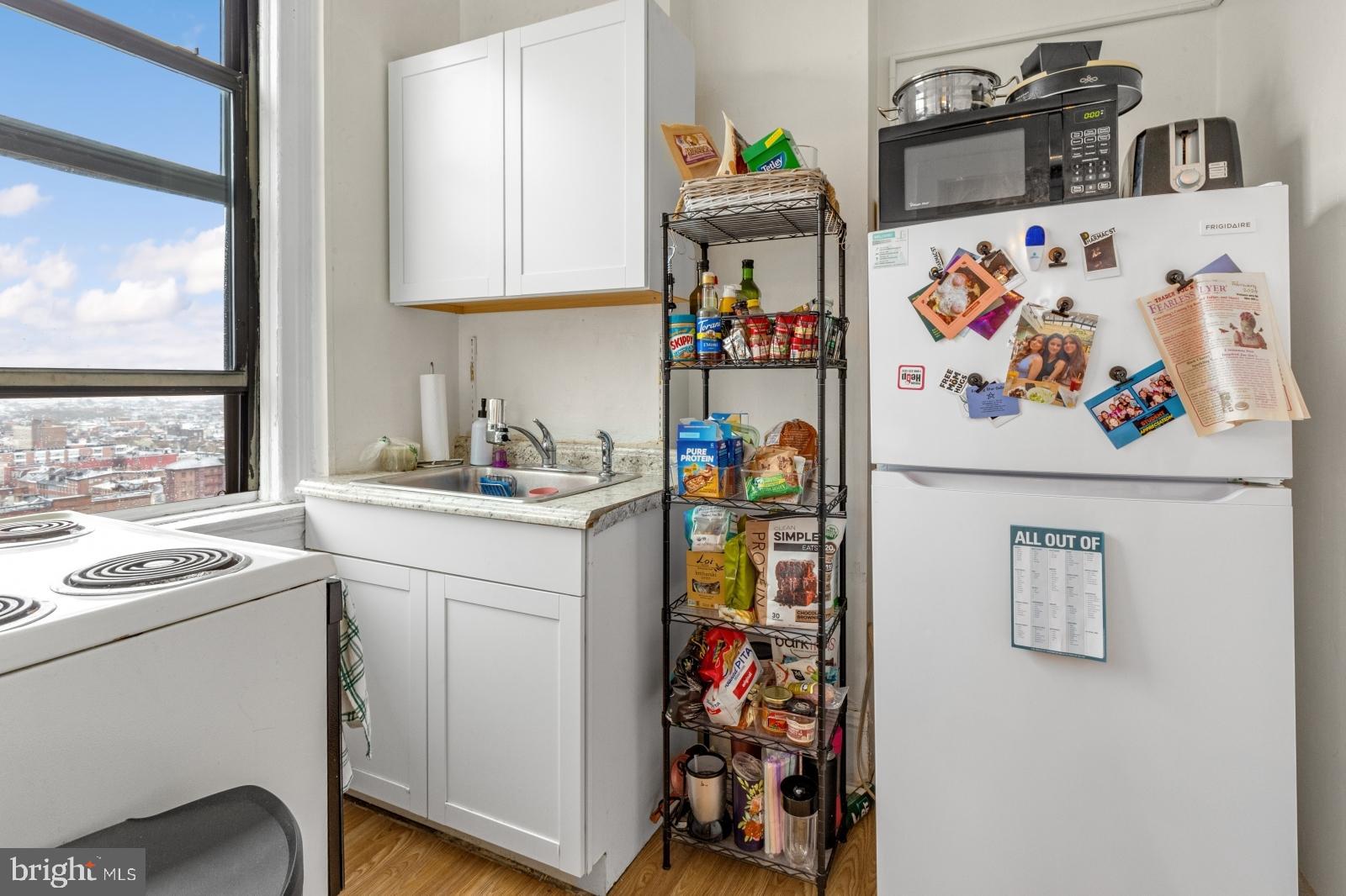1324 Locust Street, Unit 1503 Philadelphia, PA 19107 - Photo 5 of 38 a utility room with fridge dryer and washer